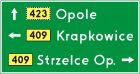 Znak E-2a Drogowskaz tablicowy umieszczany obok jezdni - drogowy kierunku miejscowości